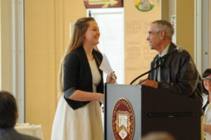 Bob Jorgensen presents the first environmental scholarship at East Peoria High School to Hannah Schroer.